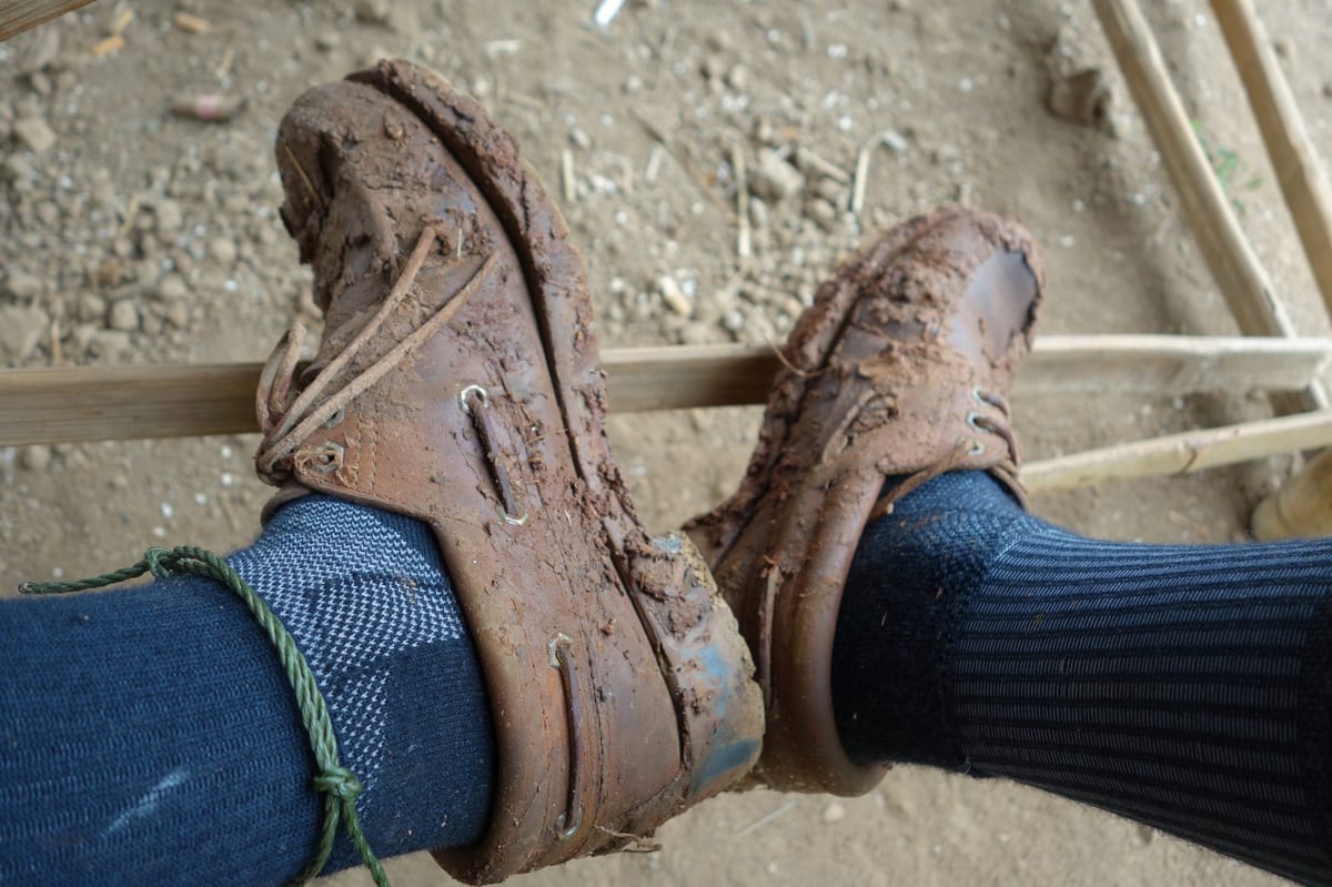 Leather boat shoes covered in mud.