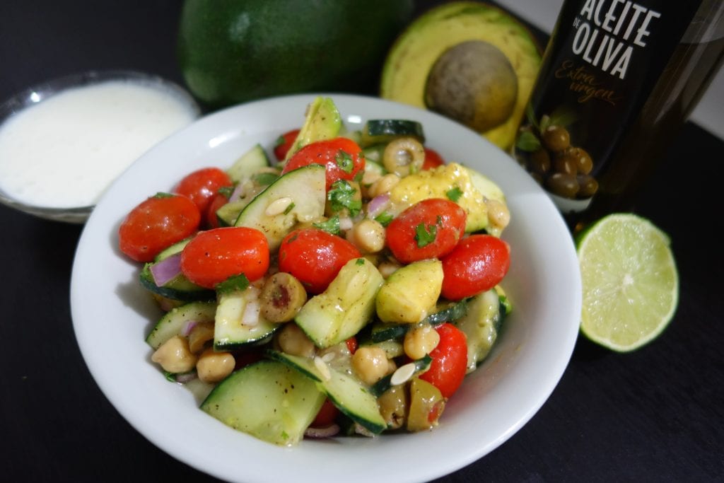 tomatoes, cucumbers, red onion, olives, avocado, chickpeas or beans, coriander, olive oil, chilli sauce, seasoning, served with yogurt